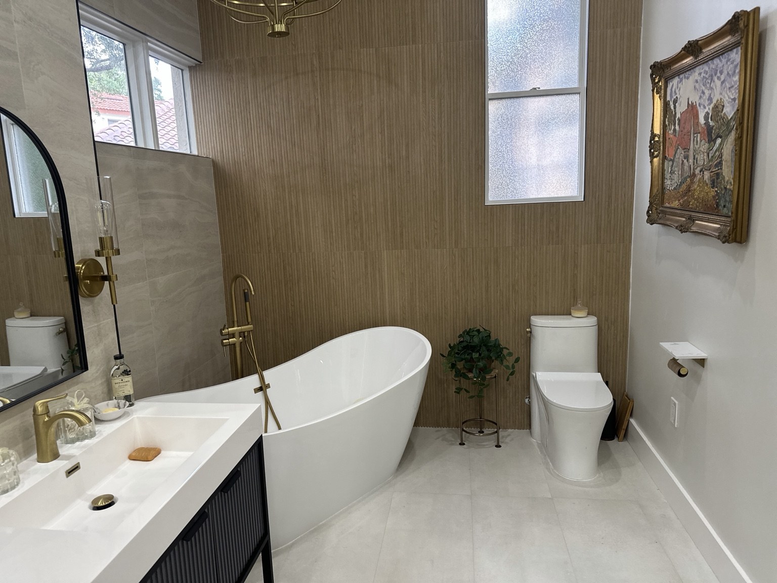 Bathroom remodel by Excellent H Services with a freestanding tub and textured accent wall