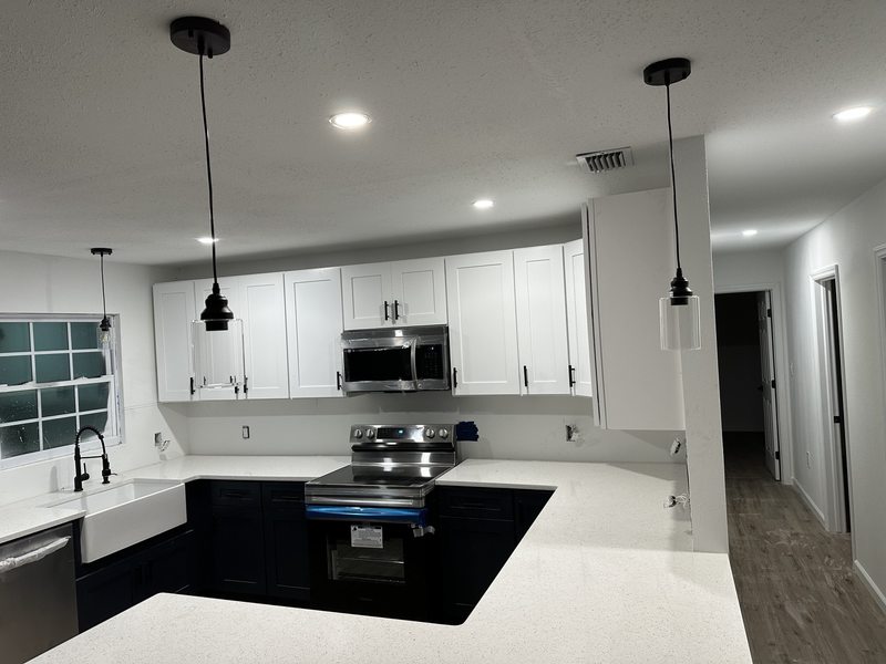 Kitchen cabinetry and pendant lighting during installation