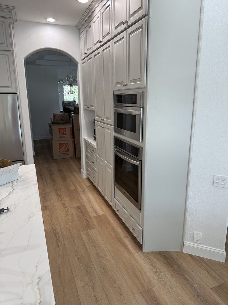 Kitchen cabinetry surrounding built-in ovens during installation