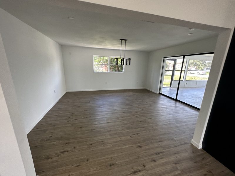 Wood-look flooring in a dining area with pendant lighting and sliding glass doors