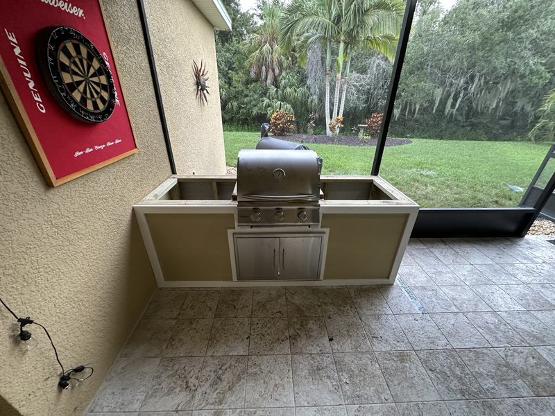 Outdoor grill and kitchen surround during installation