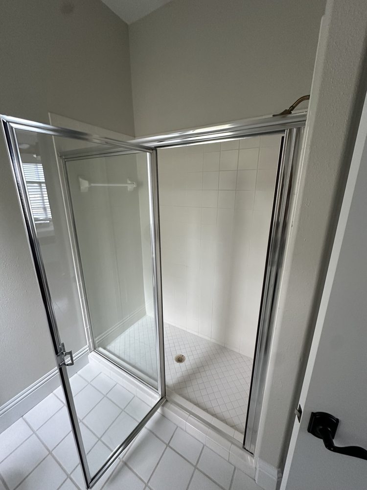Glass shower enclosure and tiled shower floor