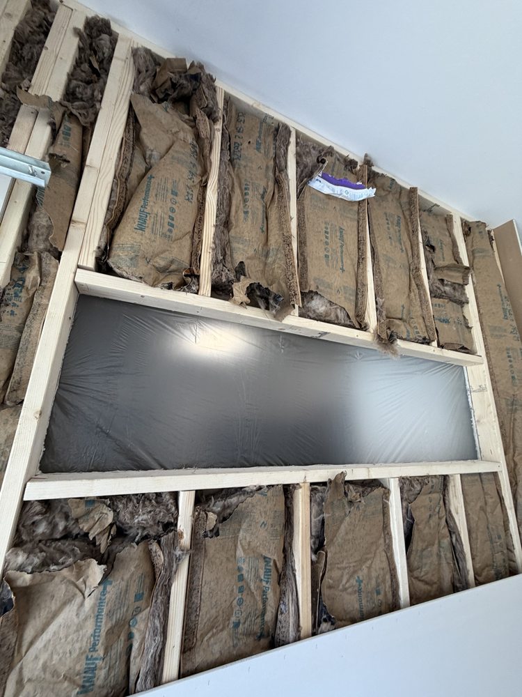 Wall framing, insulation and a horizontal window during construction