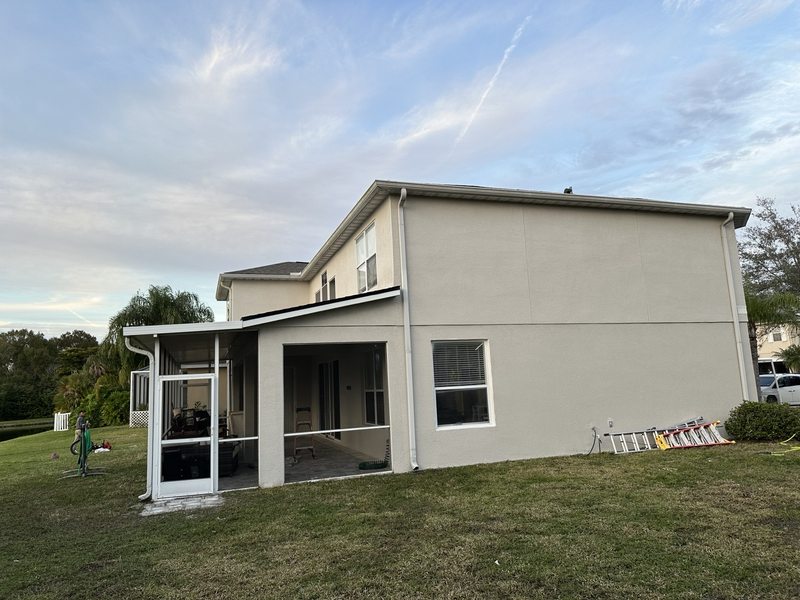 Rear exterior walls and screened patio of a house
