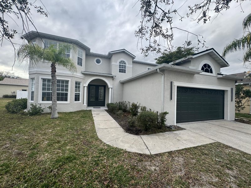 House front facade with dark garage door and light trim