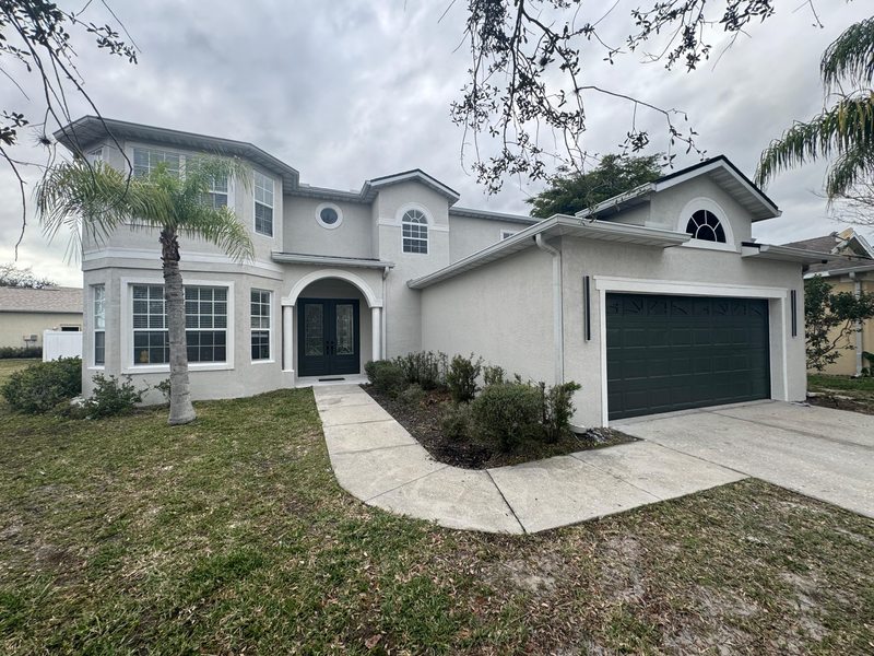 Another view of the house facade, trim and garage door