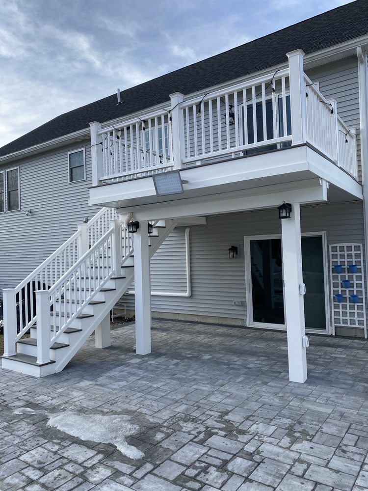 Completed exterior deck and stairs with white PVC finishes