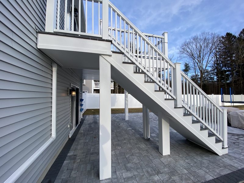 White PVC exterior trim and railing around a raised deck and stairs