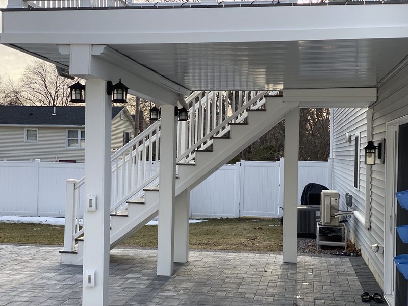 Finished exterior deck underside, white PVC post surrounds and stair details