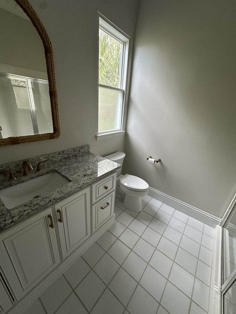 Vanity, countertop, window and bathroom floor tile