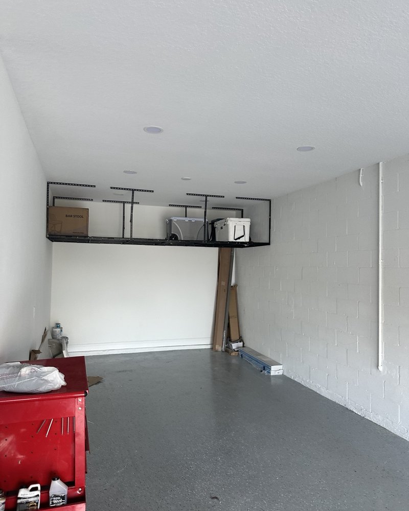 Garage with ceiling-mounted storage rack and organized overhead boxes