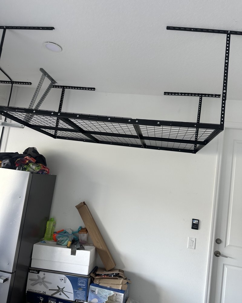 Ceiling-mounted wire-grid garage storage rack viewed from the side