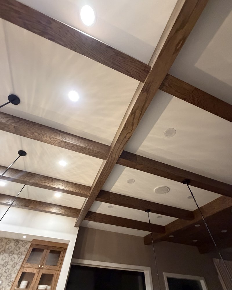 Finished decorative wood ceiling beams with recessed lighting and pendants