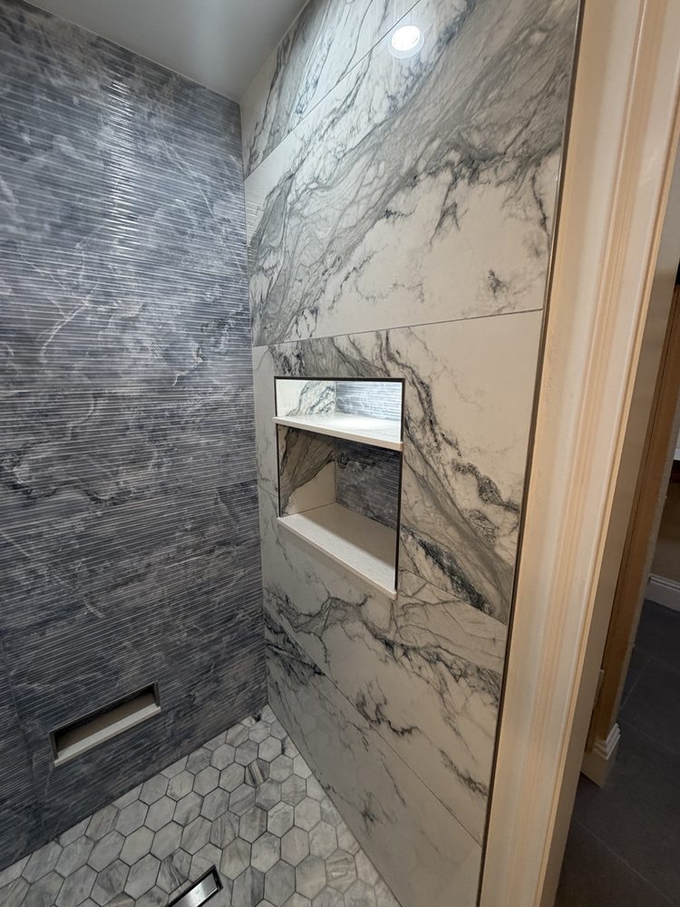 Shower featuring contrasting gray and marble-look wall tile