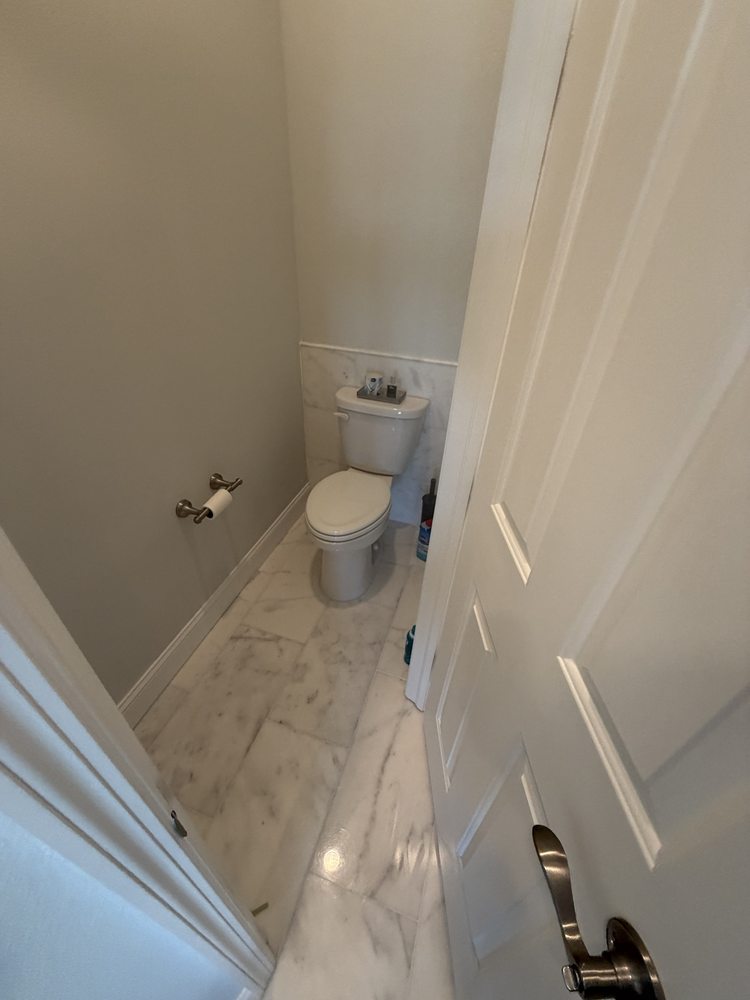 Marble-look tile floor and painted walls in a bathroom