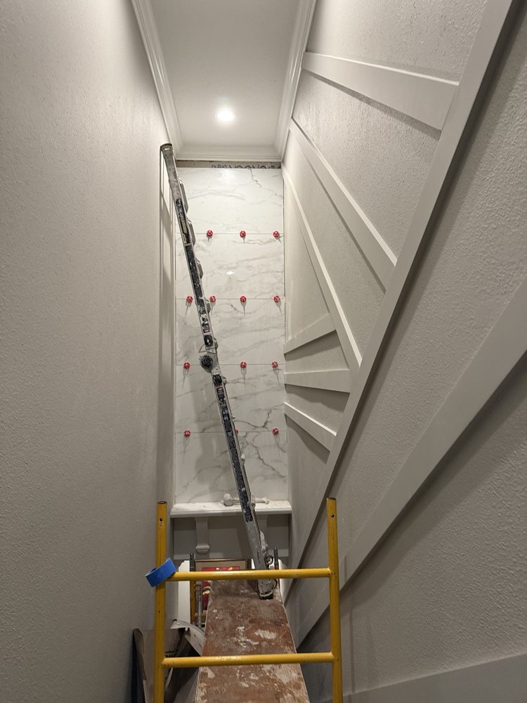Porcelain tile panel being installed with leveling clips