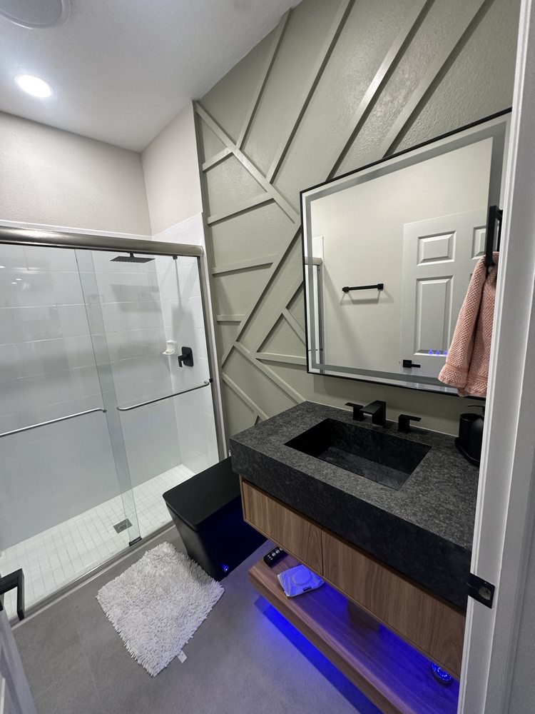 Geometric decorative wall trim behind a bathroom vanity