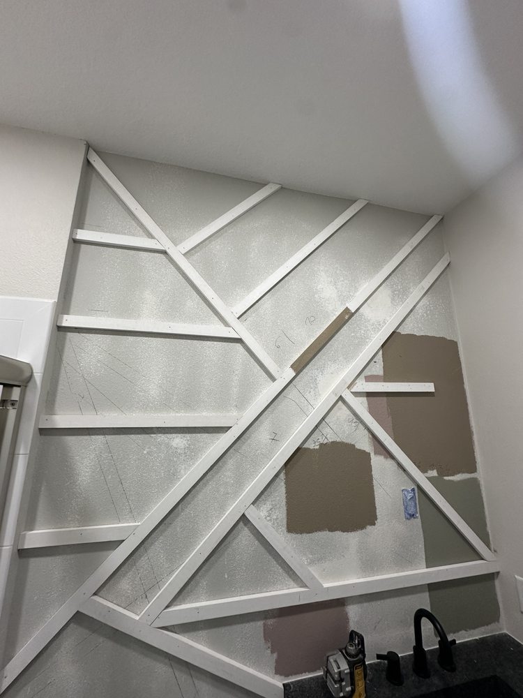 Geometric bathroom wall trim during installation