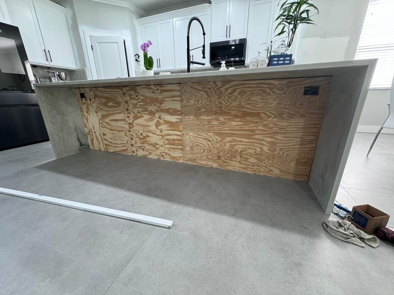 Kitchen island facing being prepared for a slatted panel installation