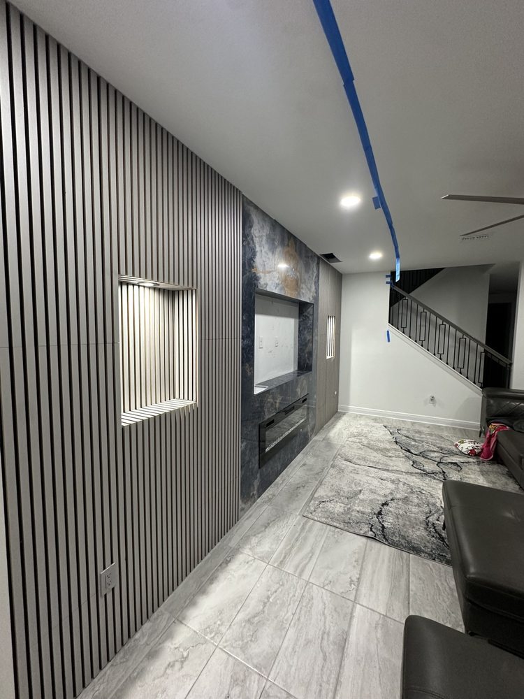 Slatted media wall and illuminated niches during installation