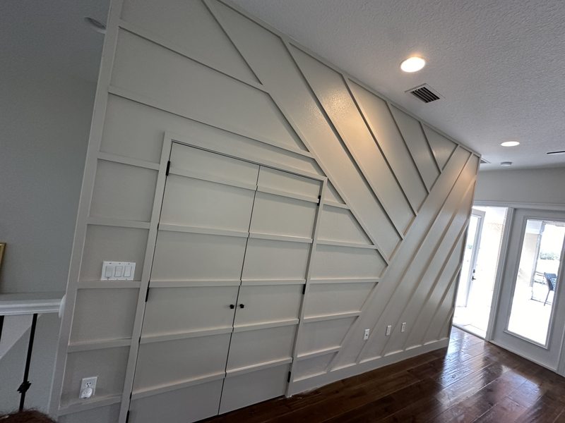 White geometric wall trim continuing across a pair of doors